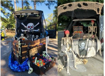 Open trunk with pirates flags coins and treasure